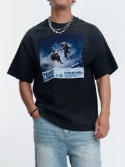 Model wearing black oversized graphic T-shirt with blue print