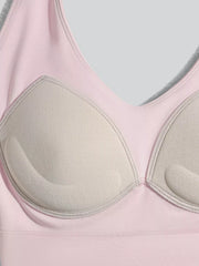 Inside of the pink active bra showing shaped cup lining and a removable pad.