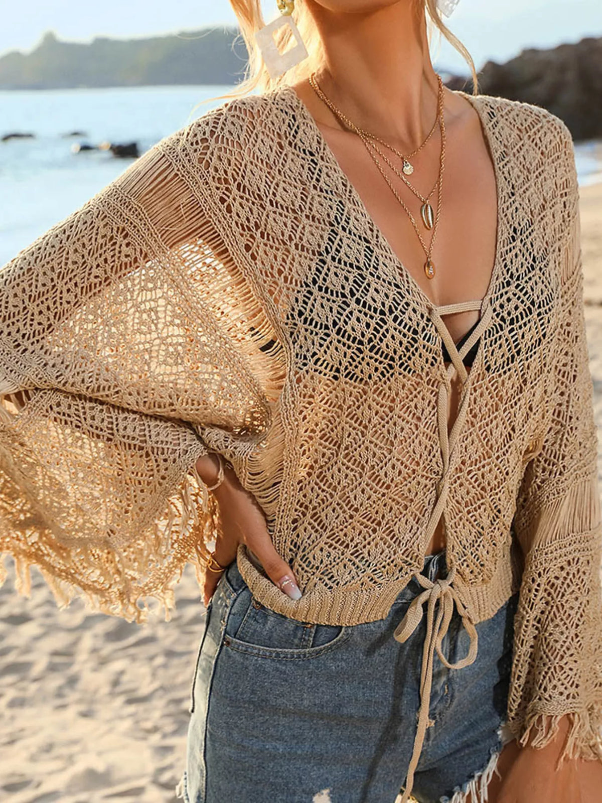 Close view of tan crochet cover-up neckline and tie front