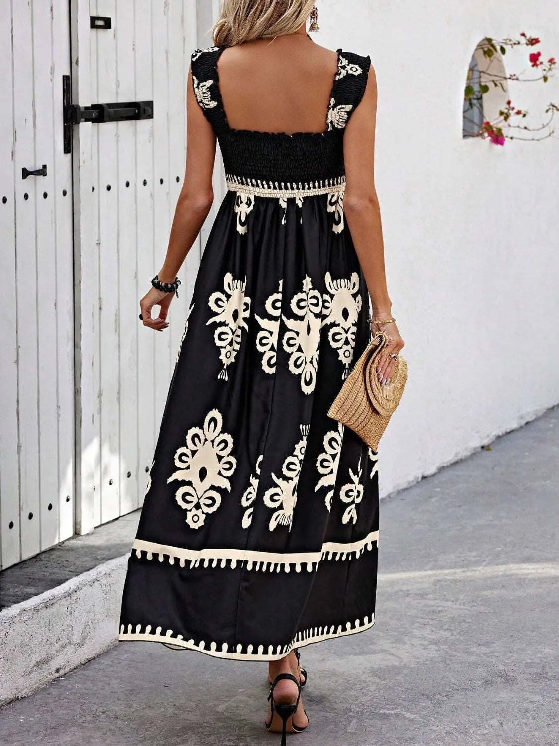 Black printed maxi dress shown with its wide shoulder straps