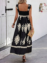 Black printed maxi dress shown with its wide shoulder straps