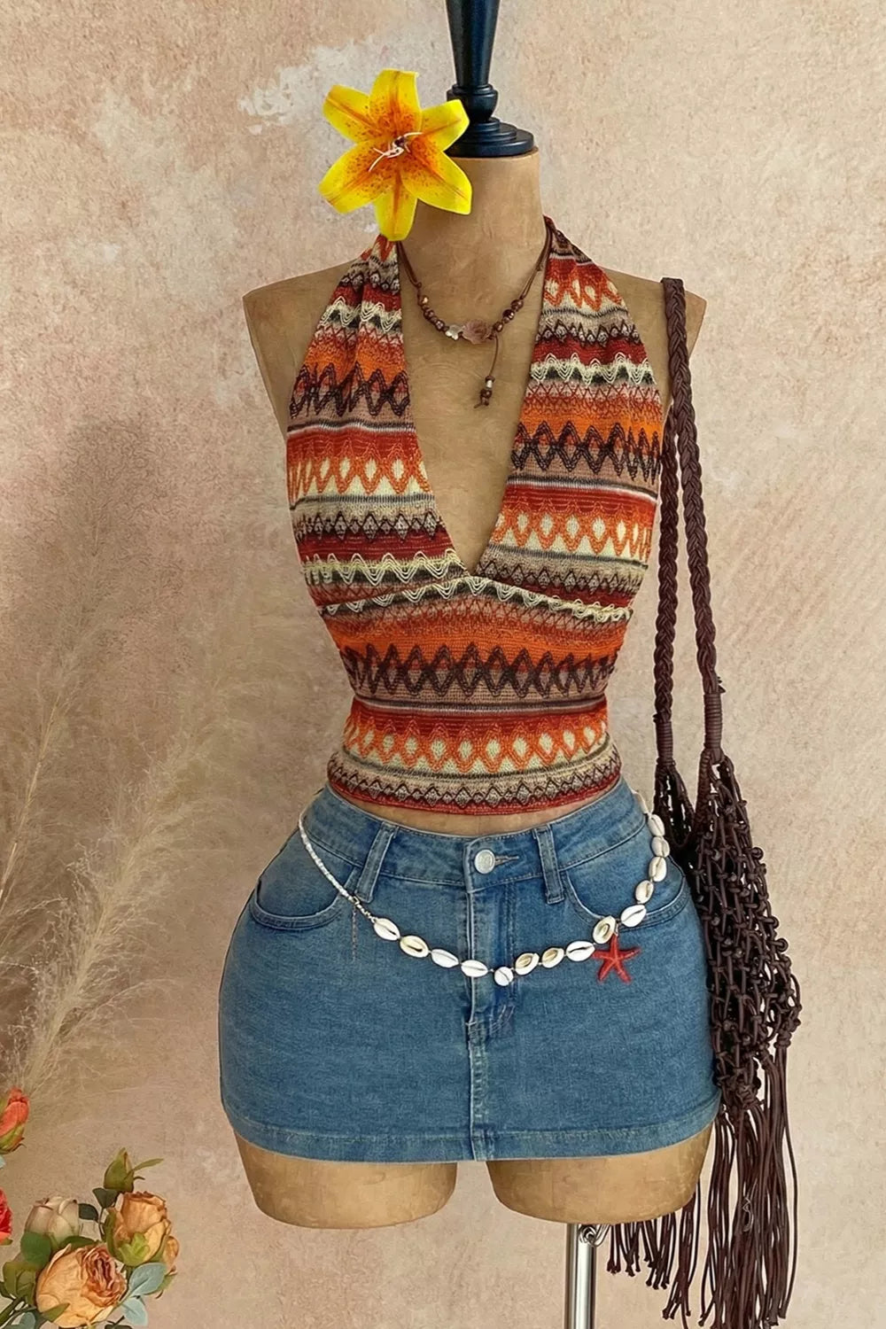 Orange geometric-print halter cami front on mannequin with denim shorts
