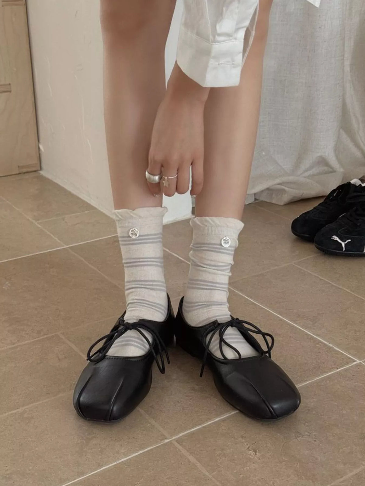 Cream mid-calf sock with gray horizontal stripes and brown toe