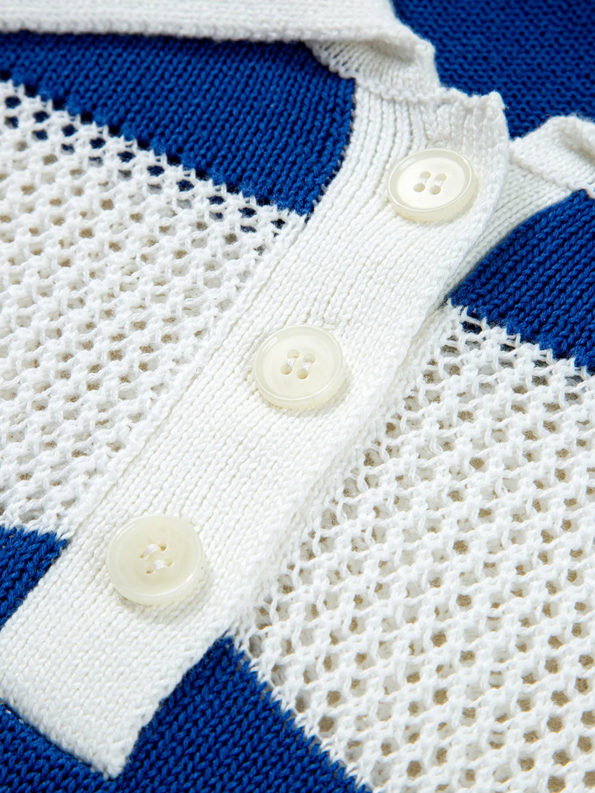 Close-up of buttons on white placket
