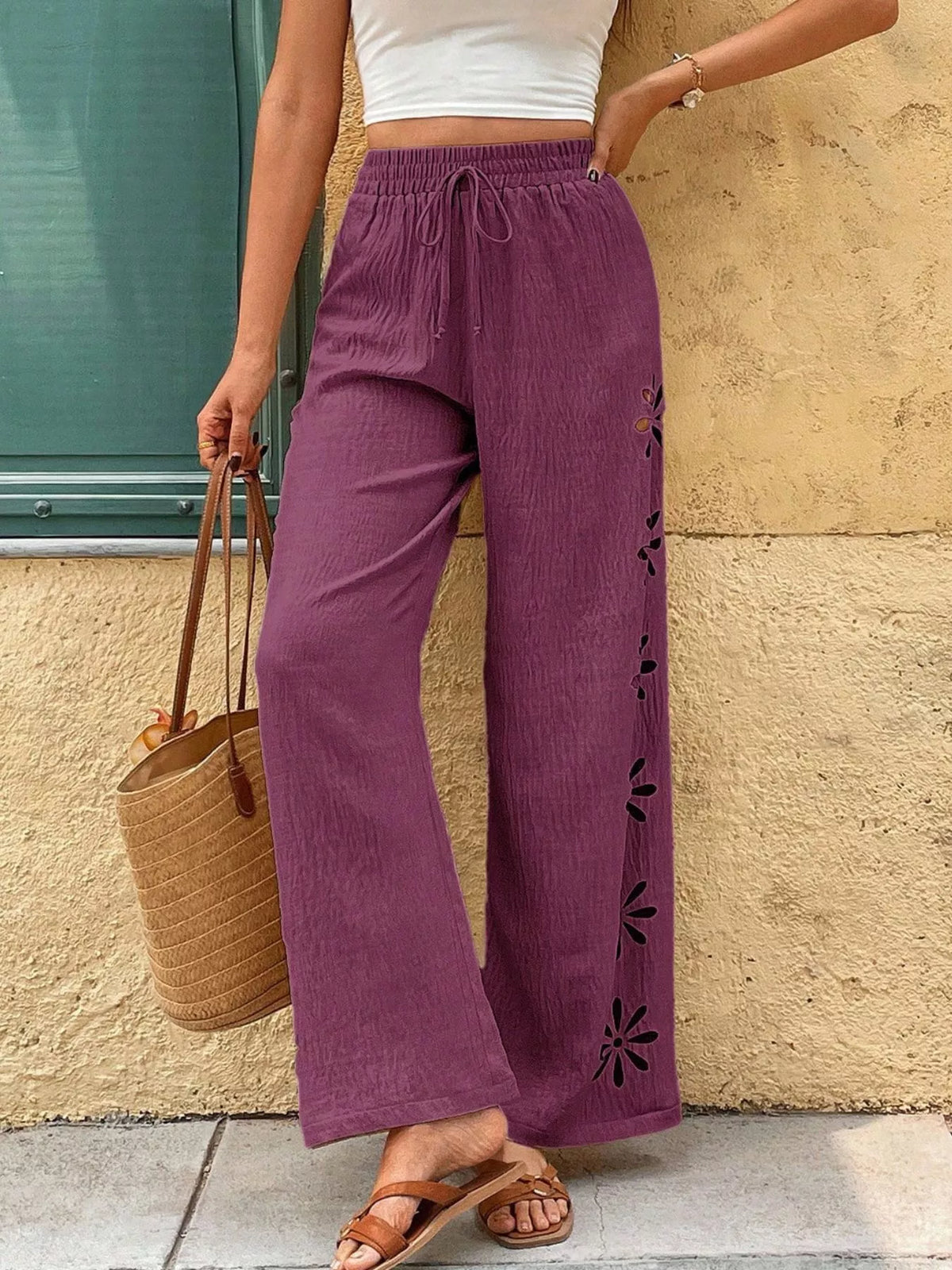 Model wearing plum wide-leg pants, front view