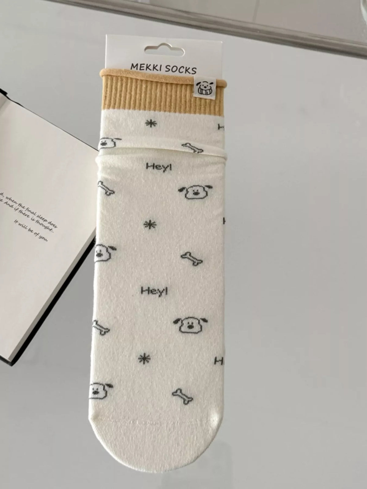 Cream cartoon-print sock shown flat