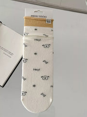 Cream cartoon-print sock shown flat