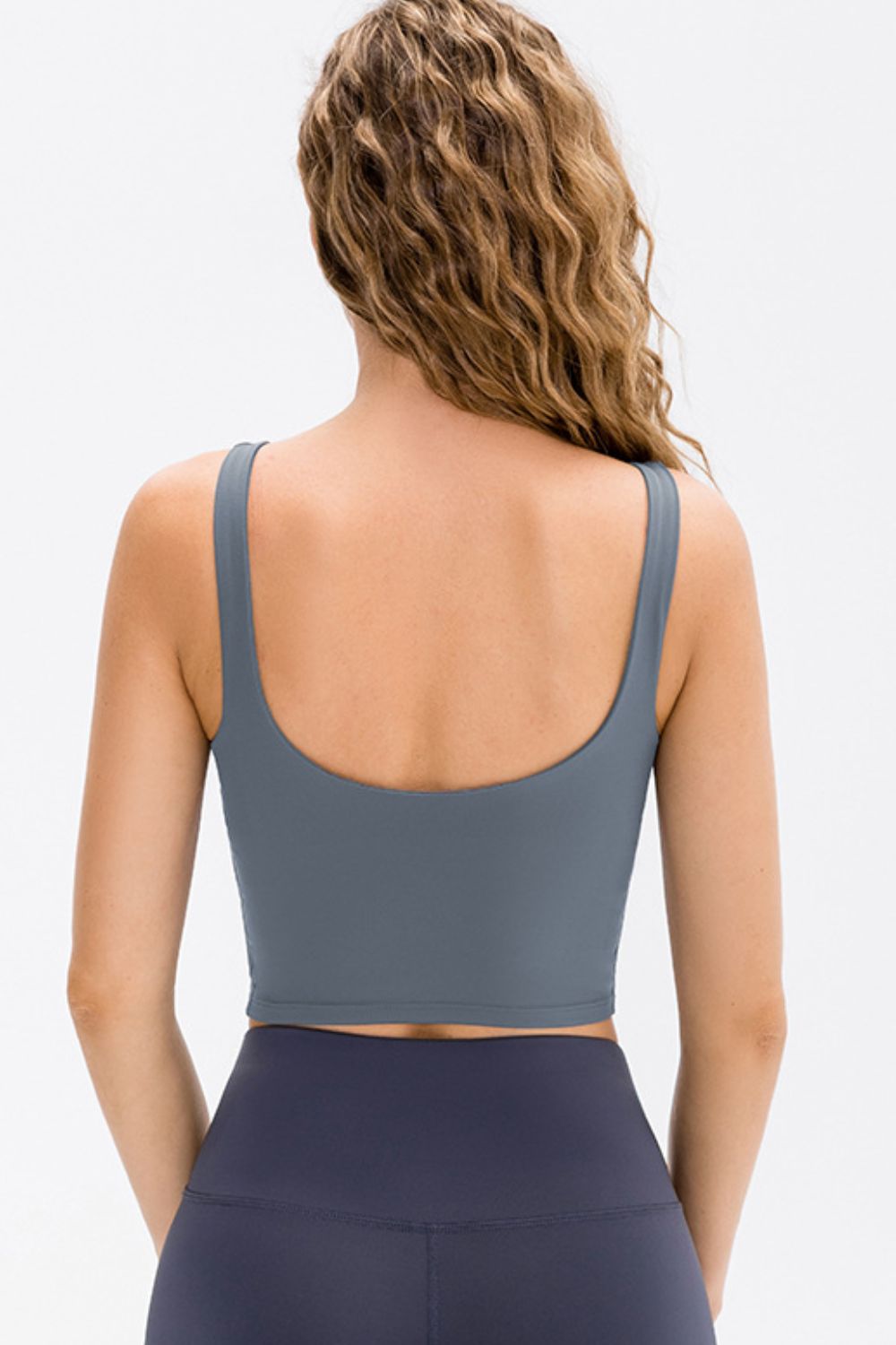 Back view of the slate blue cropped tank top with a low scoop neckline