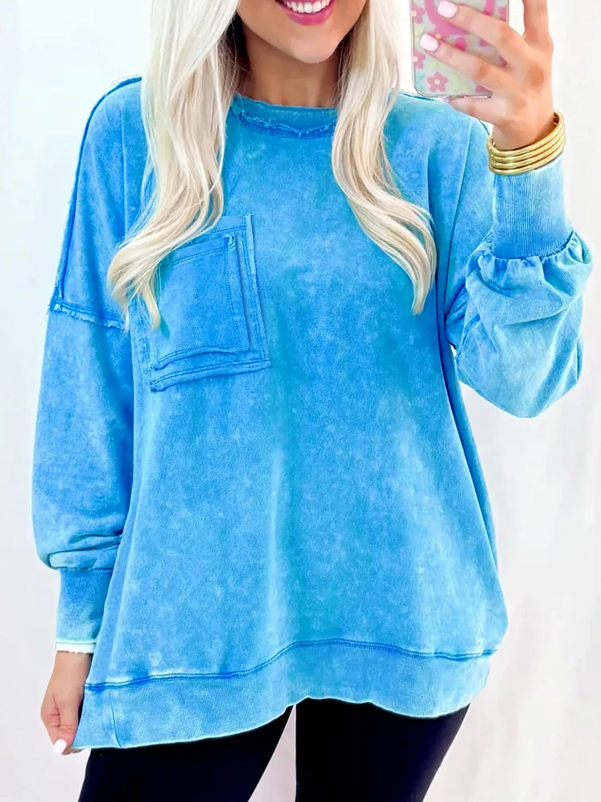 Women's mineral-wash blue raw-seam pocket sweatshirt, model front view