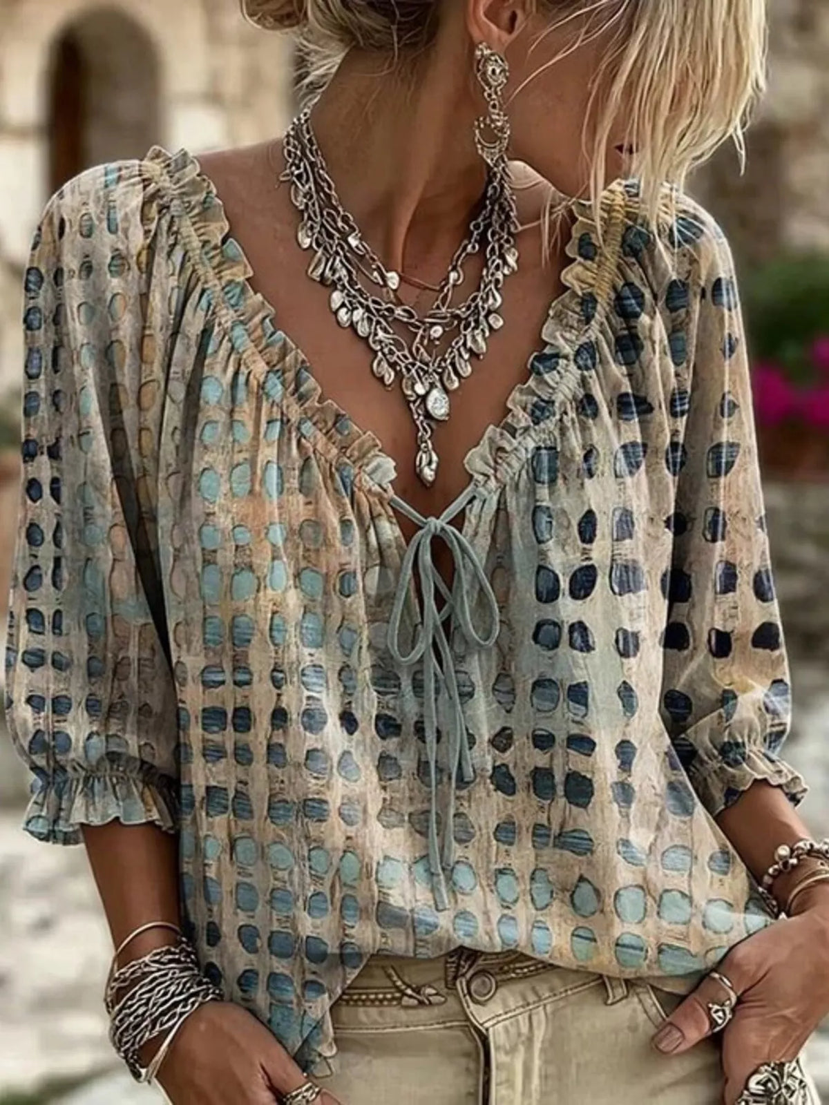 Beige and blue geometric-print tie-neck blouse, front view on a model.