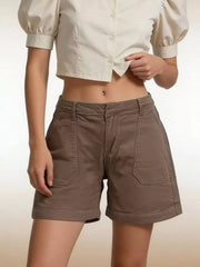 Brown pocketed denim shorts shown from the front with a beige cropped shirt