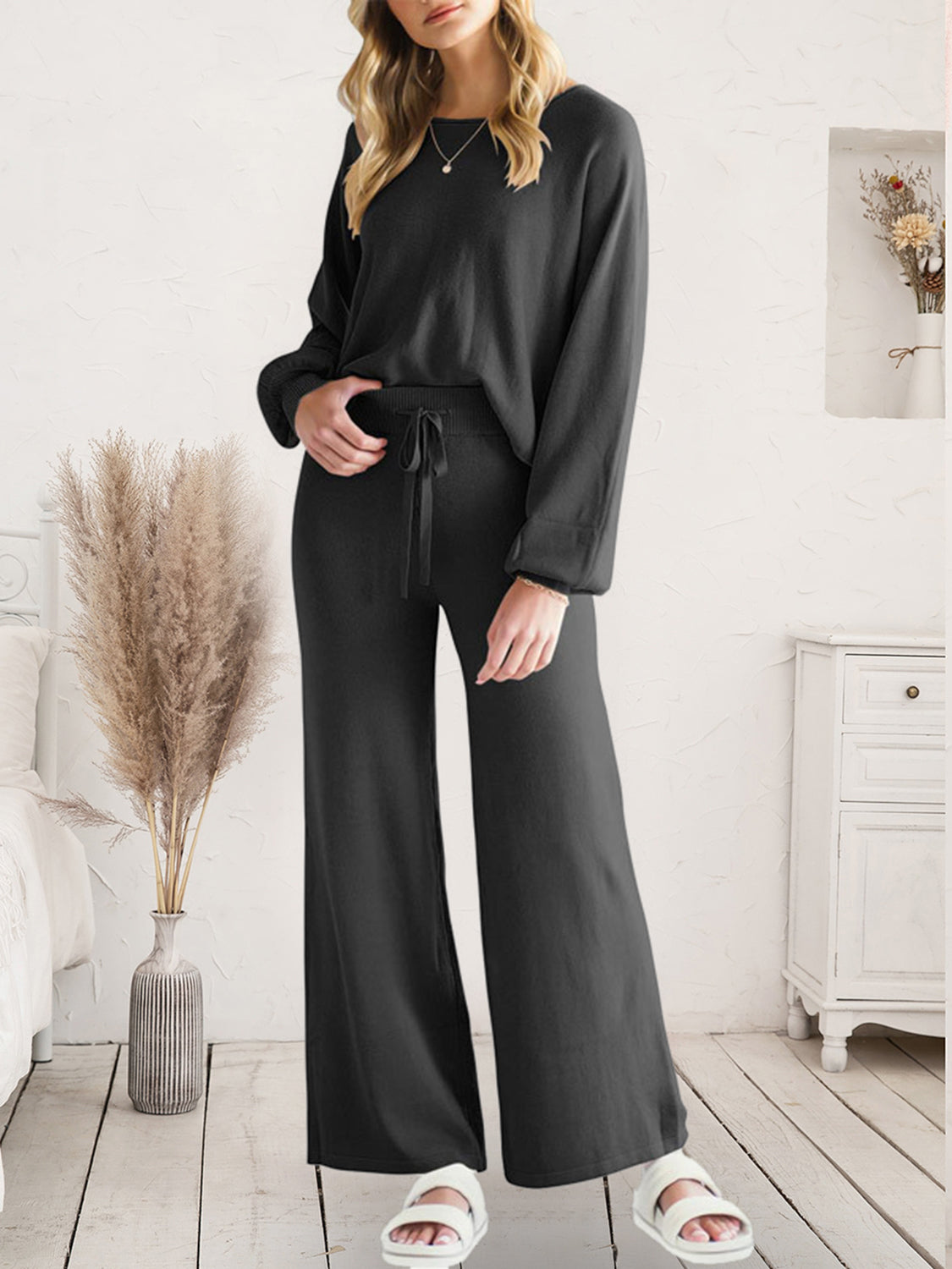 Full-length front view of black V-neck lounge top and wide-leg pants