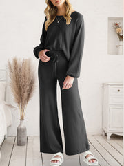 Full-length front view of black V-neck lounge top and wide-leg pants