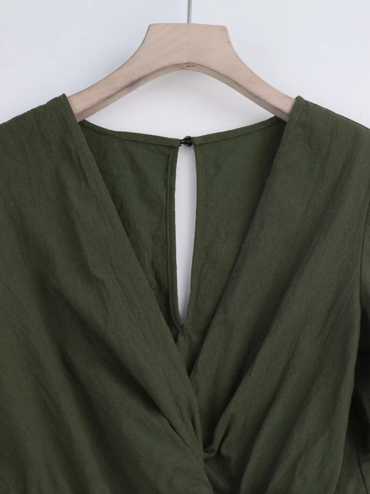 Olive romper back neckline and button detail