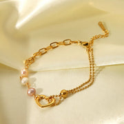 Detail of pearls and heart charm on bracelet