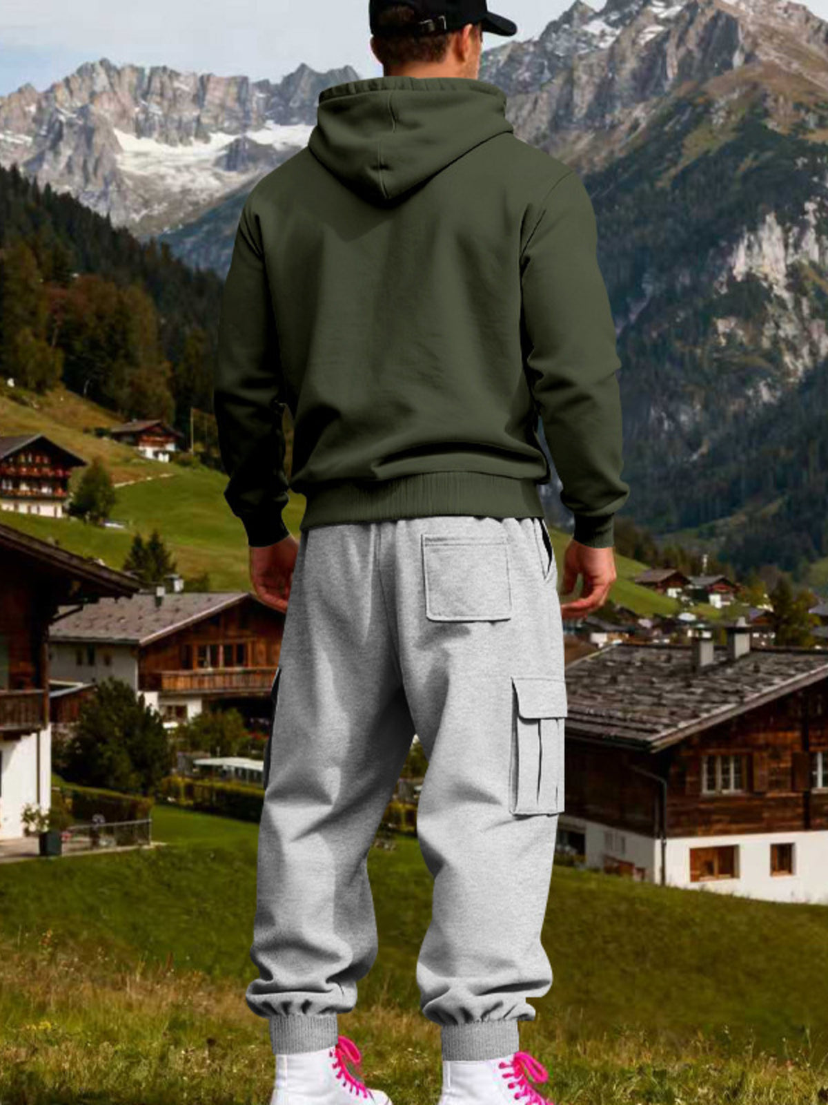 Rear view of olive hoodie and grey joggers showing the hood and back patch pocket