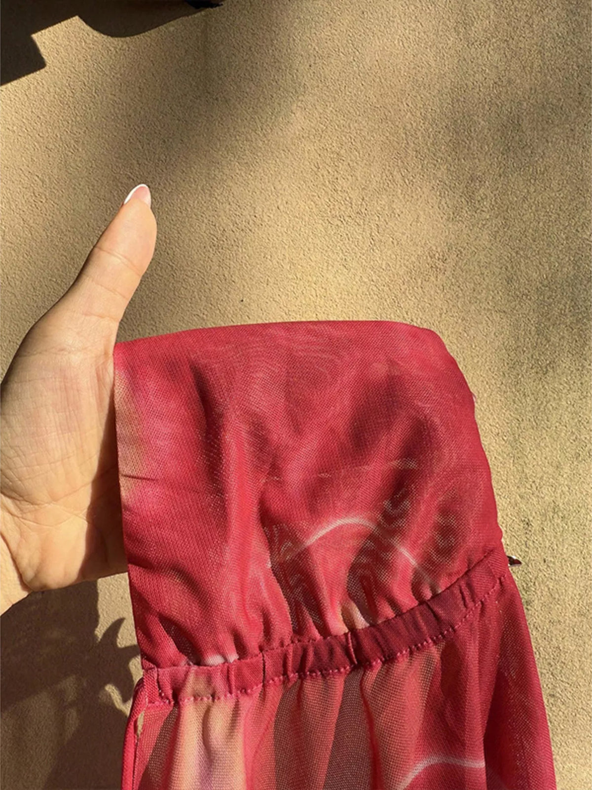 Close-up pink sheer fabric and gathered seam