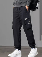 Angled front view of black joggers highlighting the large cargo pocket.