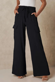Black drawstring utility trousers shown from the front with cargo pockets