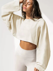 Cream cropped sweatshirt with oversized sleeves, angled front view