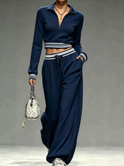 Model wearing navy half-zip crop top and matching wide-leg pants, full-length view