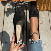 Black mesh flat beside a matching shoe, viewed from above
