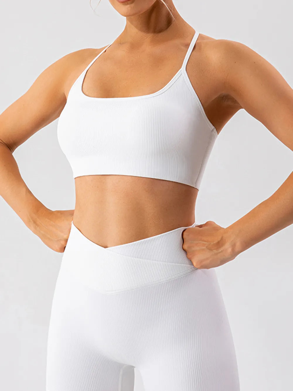 Angled front view of white active bra and matching leggings