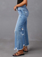 Side view of distressed flare jeans with frayed ankle hems.