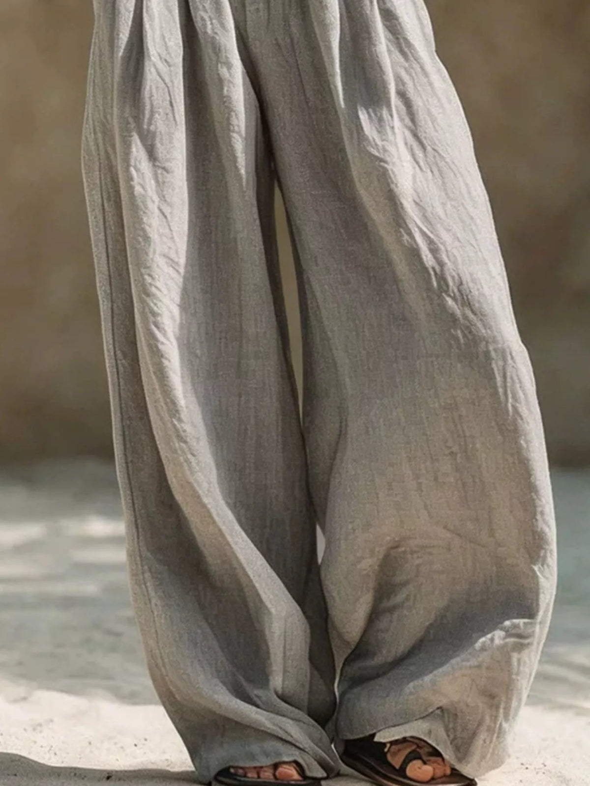 Close-up of gray wide-leg pant legs and soft draped fabric