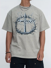 Model wearing light gray tee with ornate circular graphic