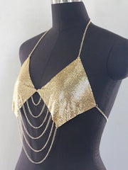Close-up of reflective gold mesh and hanging chains