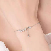 Side view of the silver leaf bracelet worn around a wrist