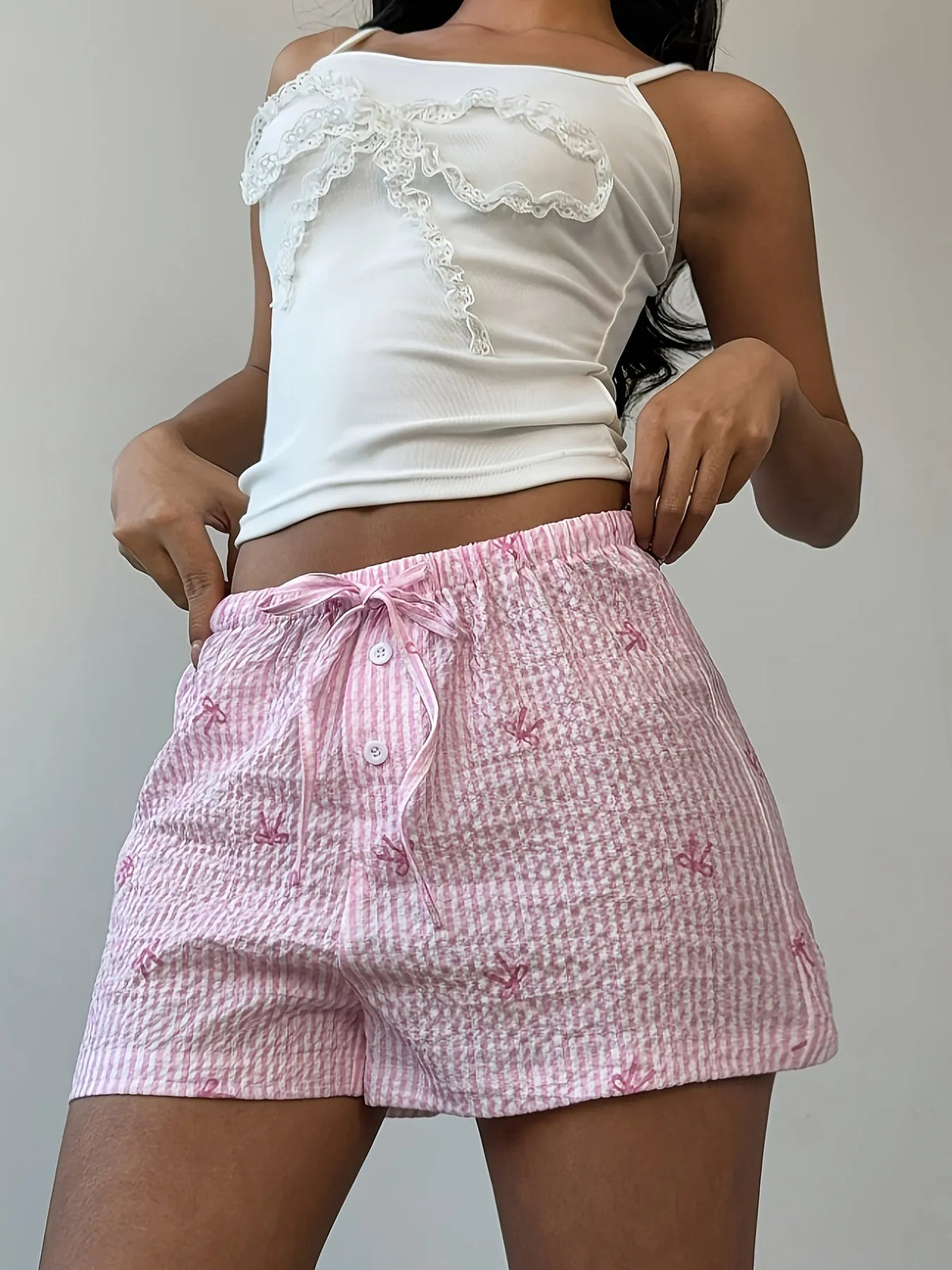 Pink check shorts with side bow accents and drawstring waist