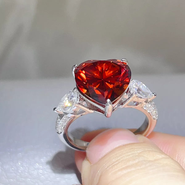 Angled view of the red heart stone and clear accent stones.
