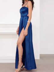 Side view of blue satin-look maxi dress showing its high slit and slim straps