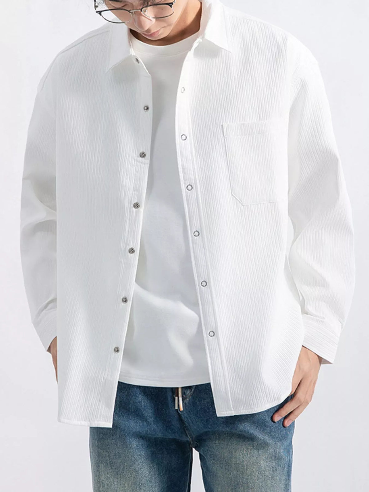 Close front view of shirt collar, buttons, and chest pocket