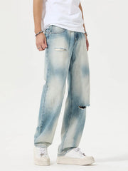 Angled front view of light-wash distressed relaxed jeans