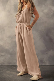 Khaki textured jumpsuit, model angled side view with hand in pocket