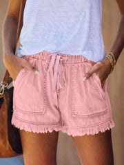 Pink drawstring denim shorts with front patch pockets and frayed hems