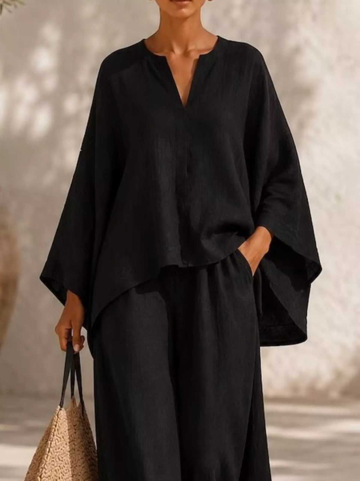 Closer front view of the black set highlighting its loose sleeves and waist tie.