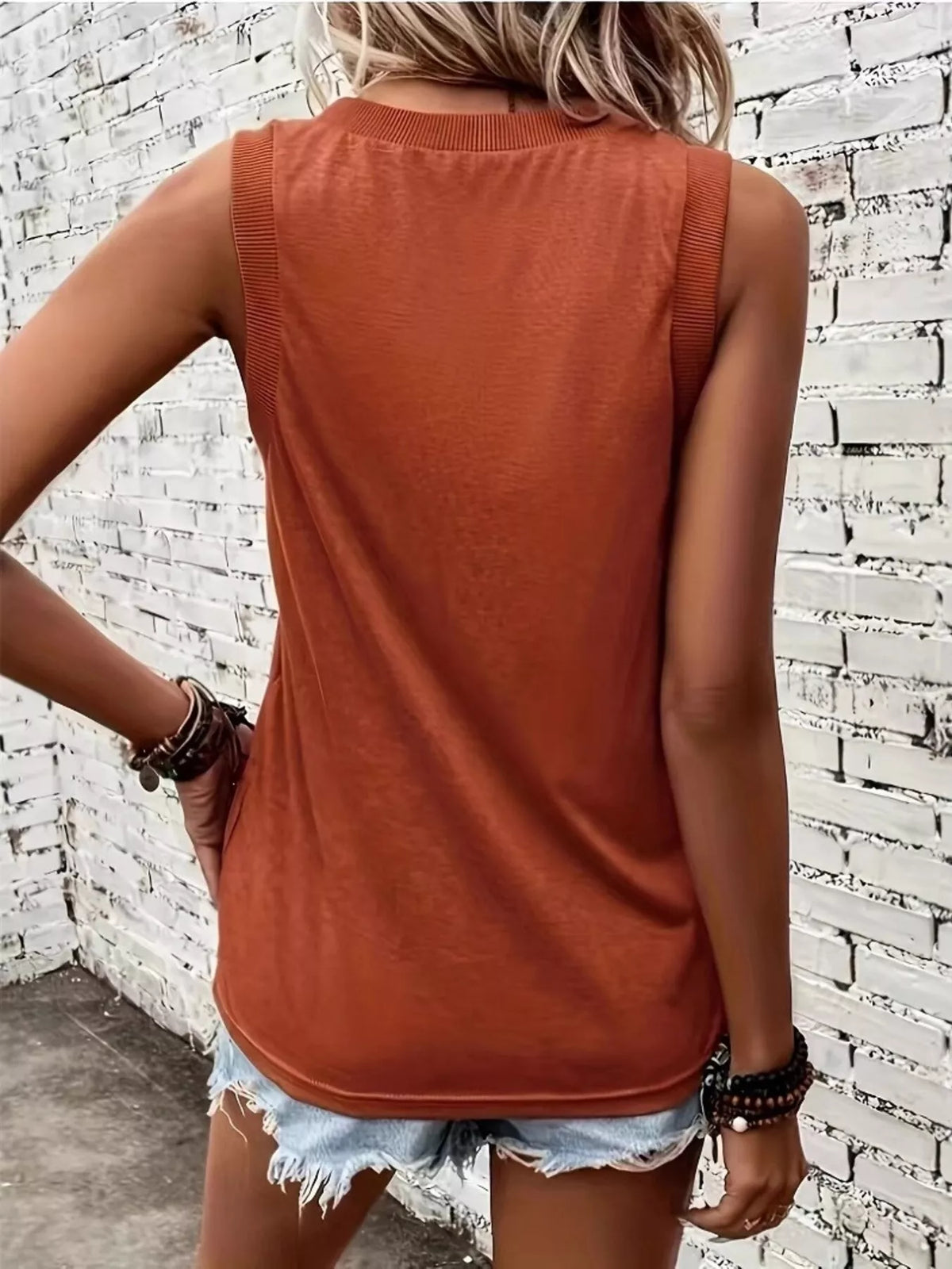 Close-up of V-neck and shoulder straps on orange tank