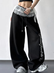 Black wide-leg pants with layered white lace waist detail