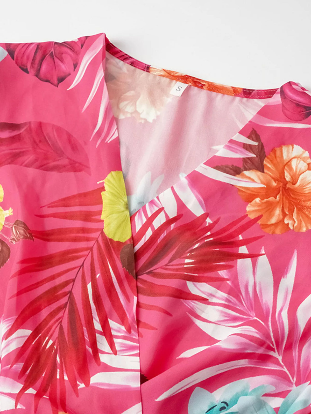 Close-up of tropical print belt and buckle