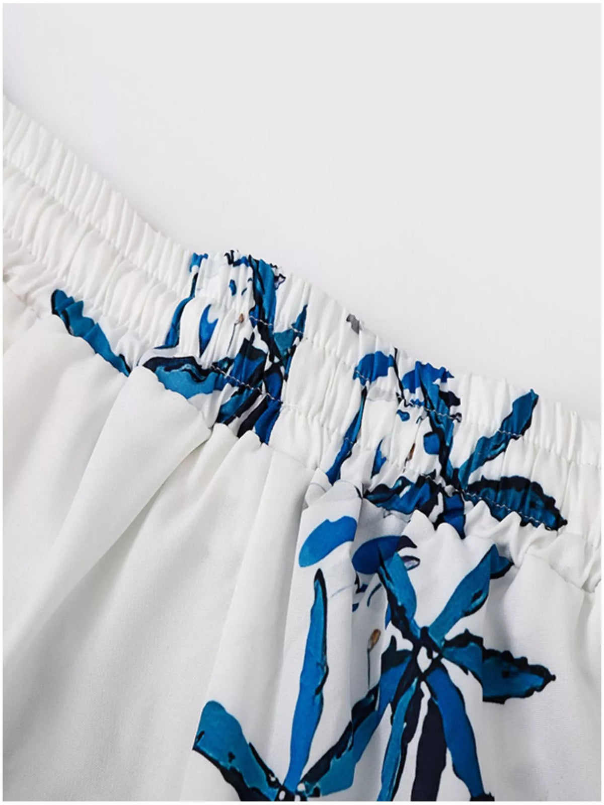 Close-up of the gathered elastic waistband on the printed shorts