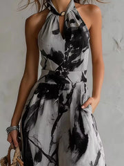 Close-up of the grey and black jumpsuit's halter neckline and defined waist.