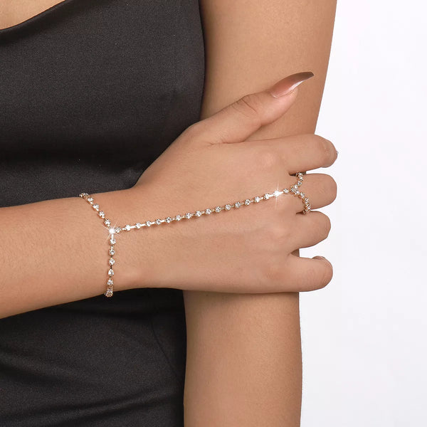 Close view of rhinestone bracelet chain across hand and finger ring
