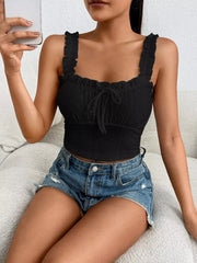 Model wearing black tie-front eyelet tank with ruffled straps
