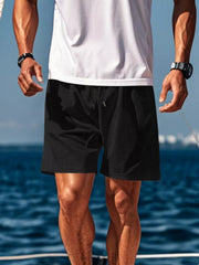 Side view of black drawstring shorts on a model