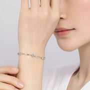 Model wearing the slim silver-tone zircon flower bracelet beside the face