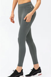 Black leggings styled with a phone in the side pocket and a towel at the hip